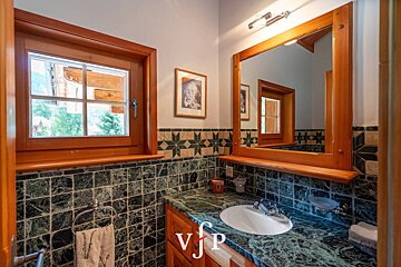 A bathroom with a sink and a mirror with the letters vjp on the counter