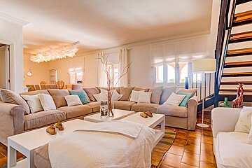A living room filled with furniture and a staircase