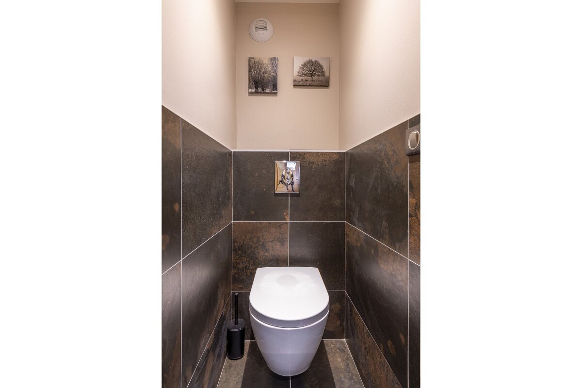 A large building in the middle of a valley with mountains in the background