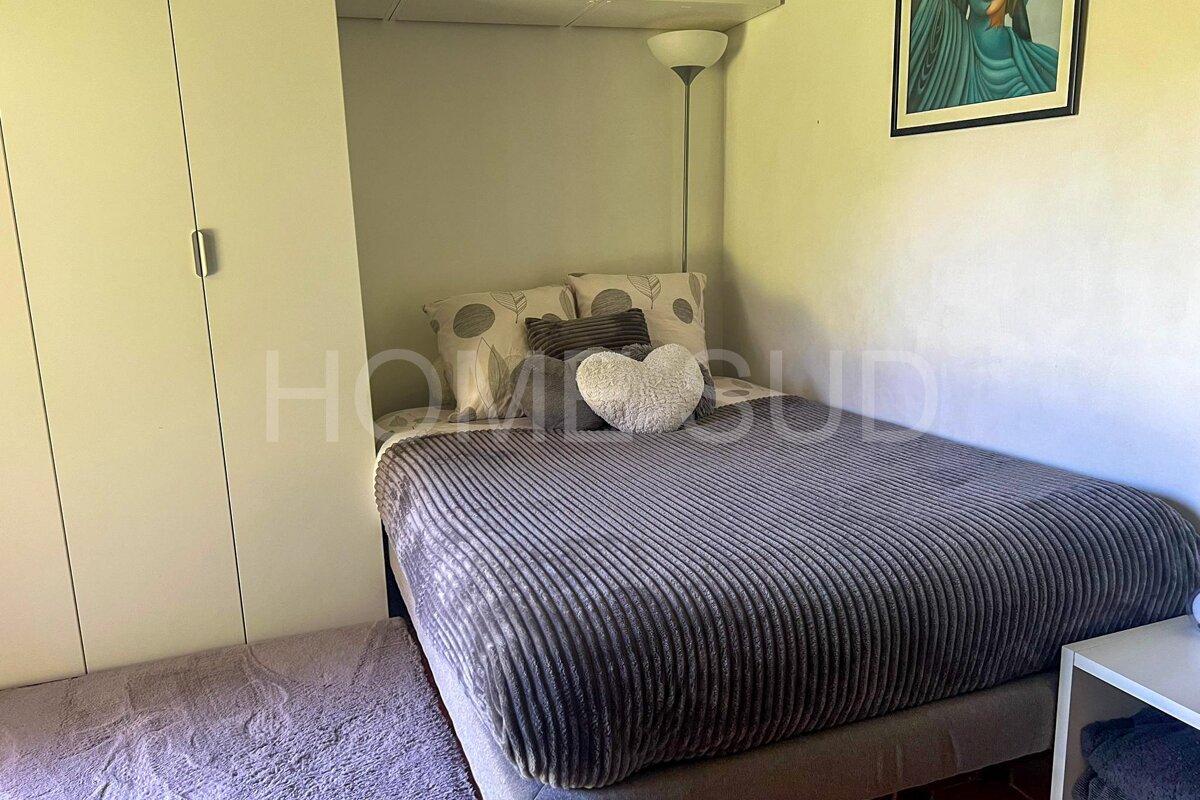 A bedroom with a bed and a picture above it that says home bud