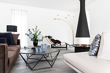 A living room with a couch a coffee table and a fireplace