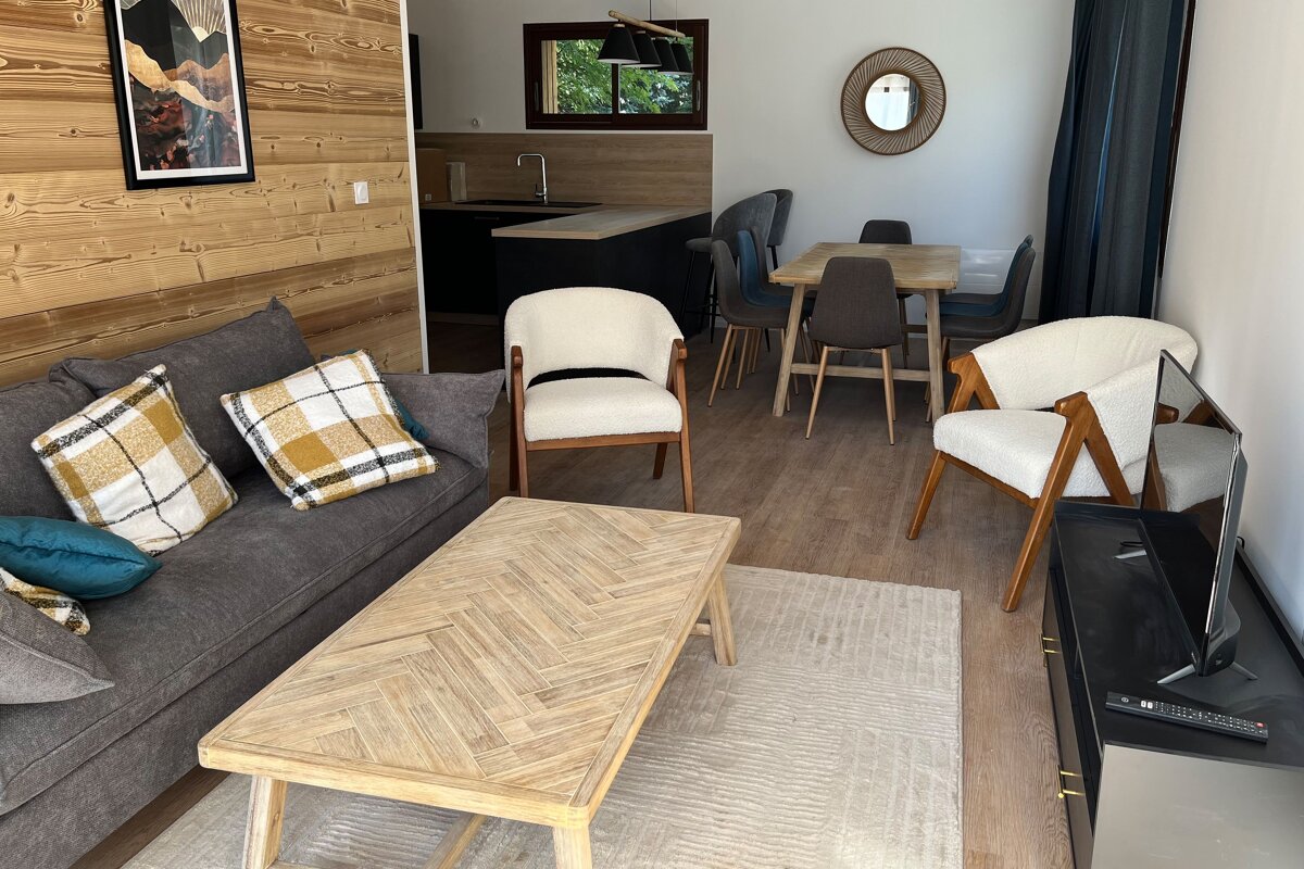 A living room with a couch a table and chairs