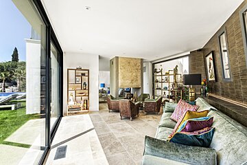 A living room with a couch and chairs and a fireplace