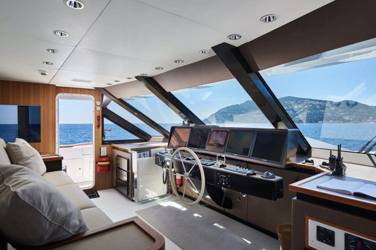 A boat with a steering wheel and monitors on it