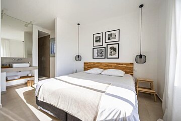 A bedroom with a large bed and a sink