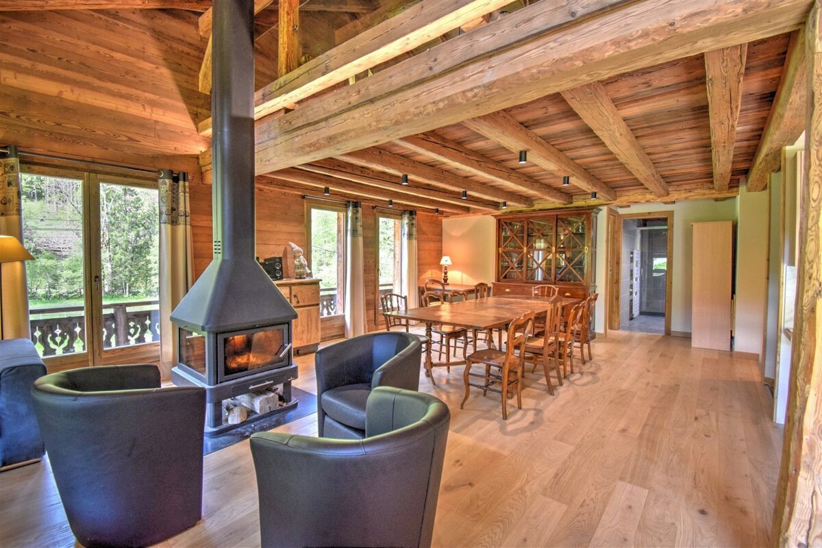 A living room with a fireplace and a dining table