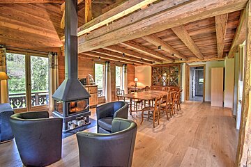A living room with a fireplace and a dining table
