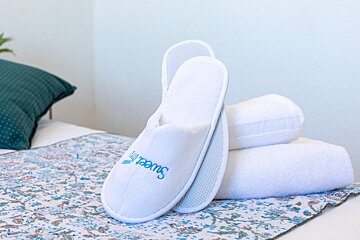 A pair of white slippers with the word sweet on them