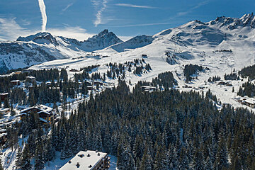 An aerial view of a ski resort with mountains in the background