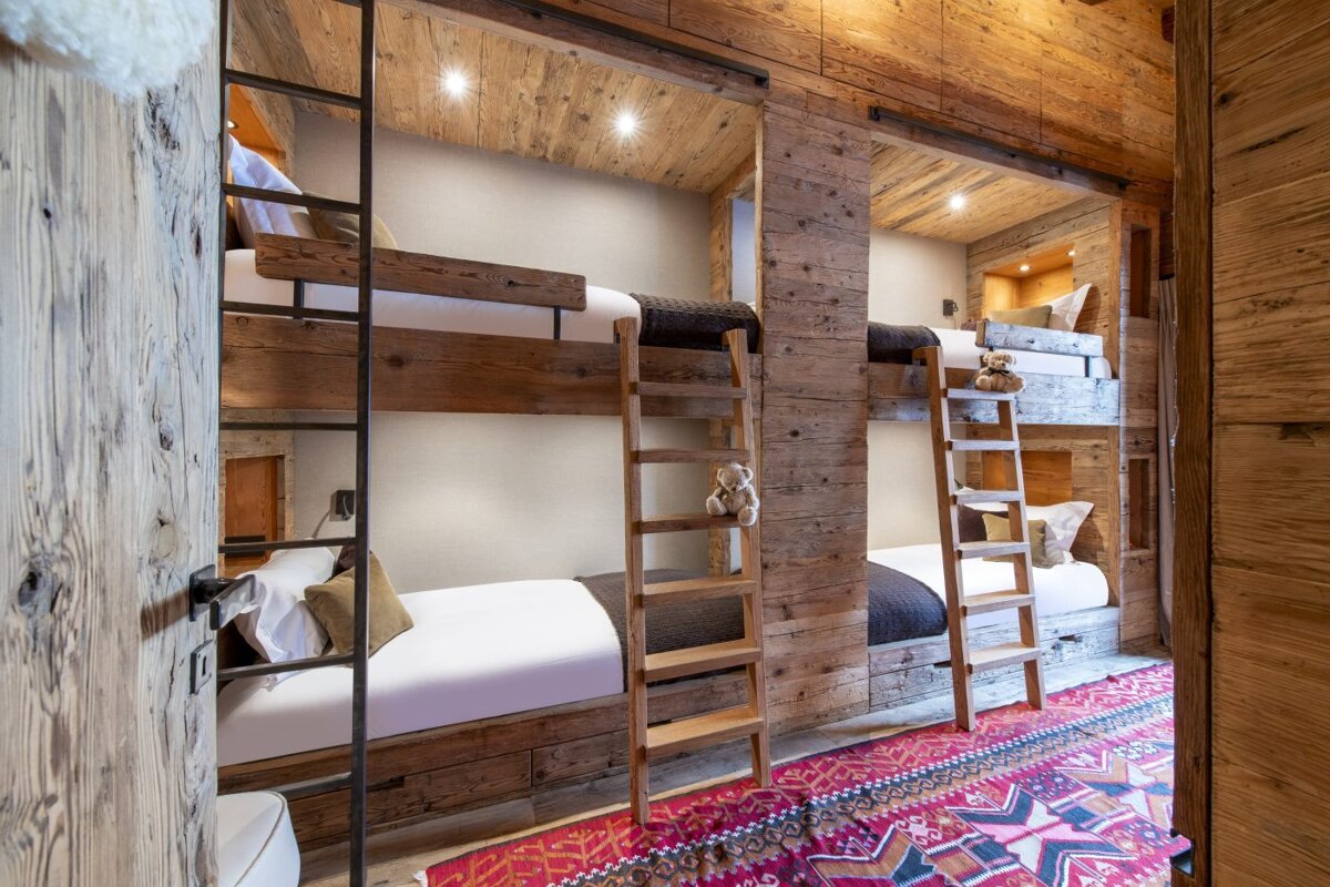 A bunk bed with a ladder leading up to it