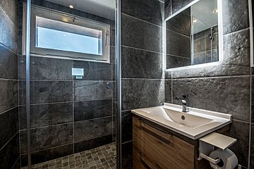 A bathroom with a sink a mirror and a window