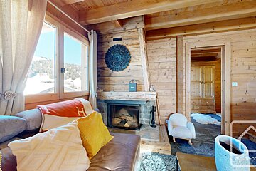 A living room with a fireplace and a sign that says alpine-prop