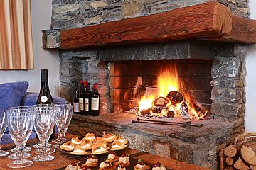 A fireplace with a few bottles of wine on it