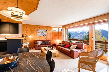 A living room with a view of the mountains