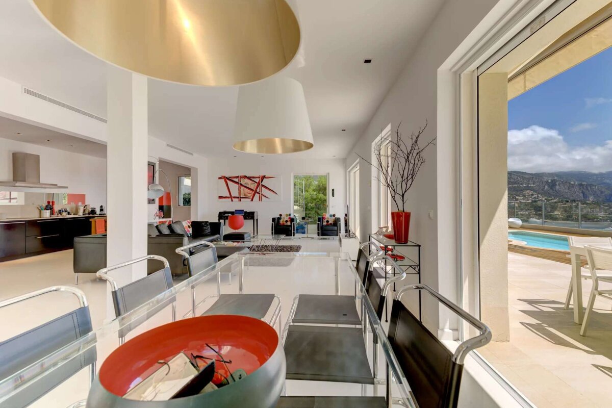 A dining room table with a red bowl on it