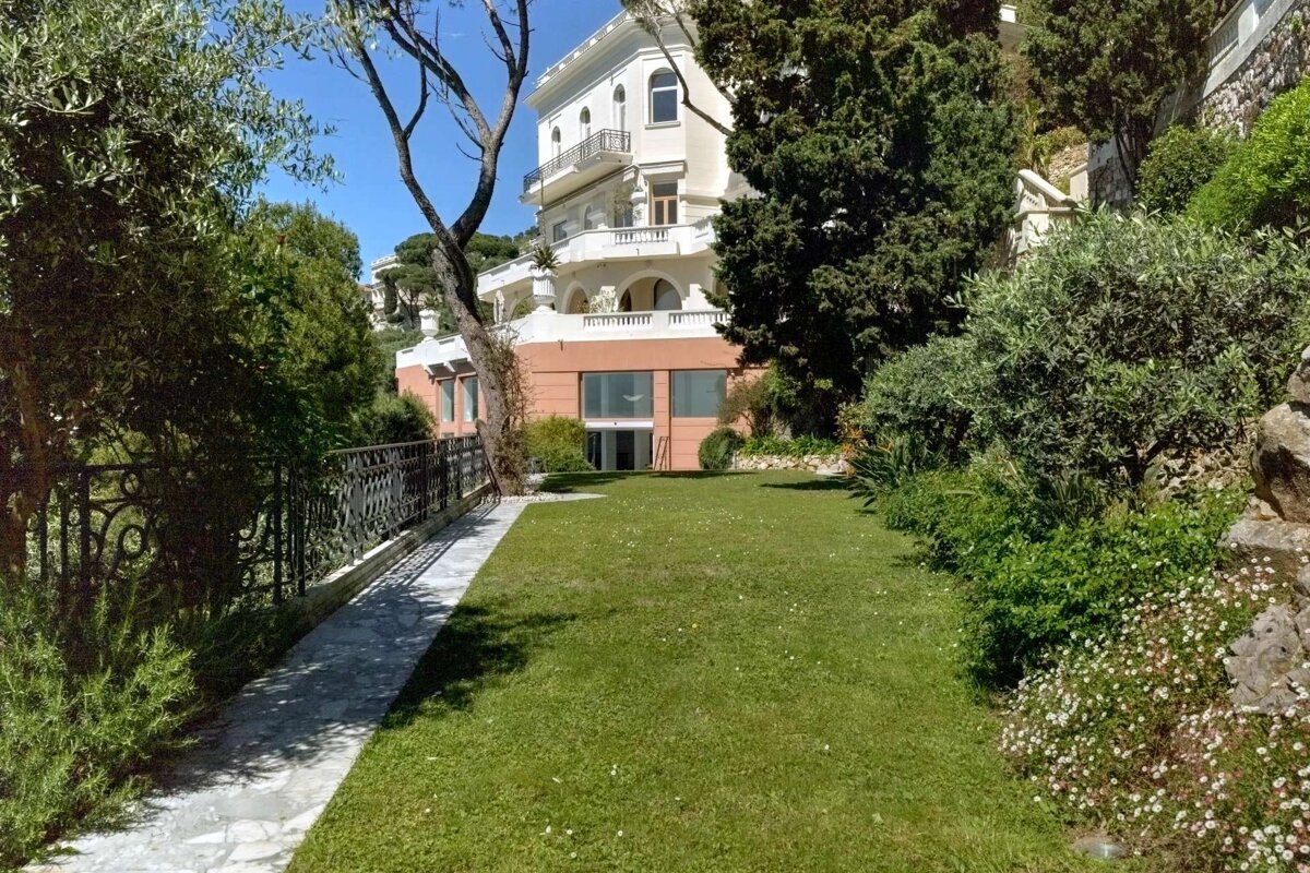 A large house with a large lawn in front of it