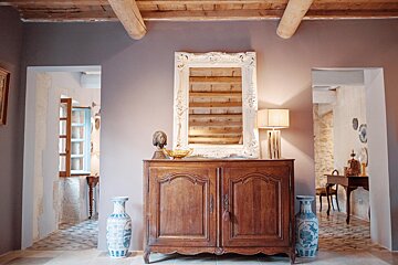 A wooden dresser with a mirror on top of it