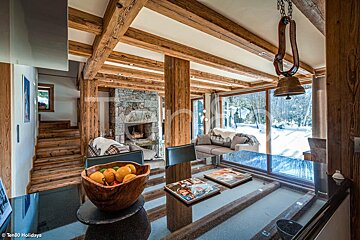 A bowl of fruit sits on a table in a living room
