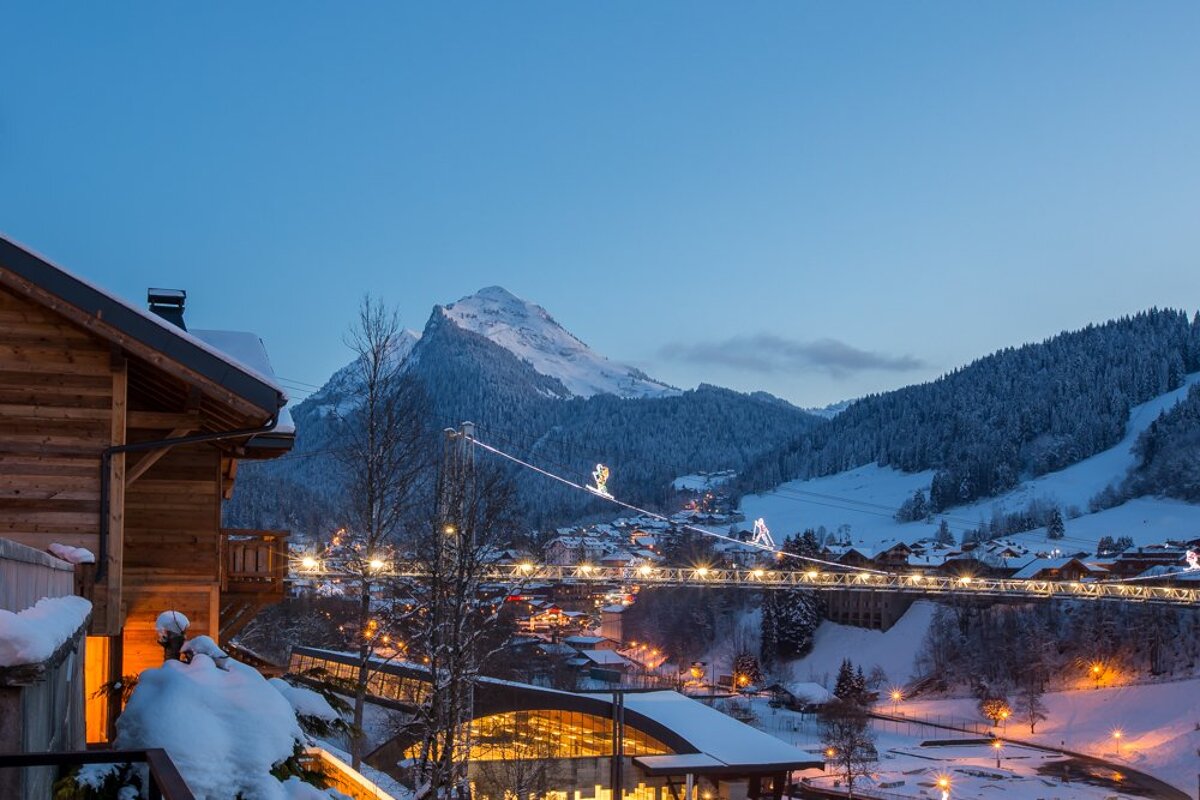 A snowy landscape with a mountain in the background