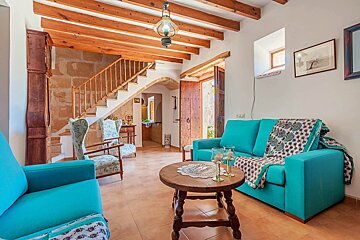 A living room with a blue couch and chairs