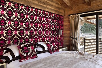 A bedroom with a bed and a sliding glass door