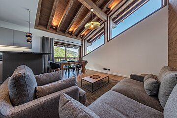 A living room with a couch and two chairs
