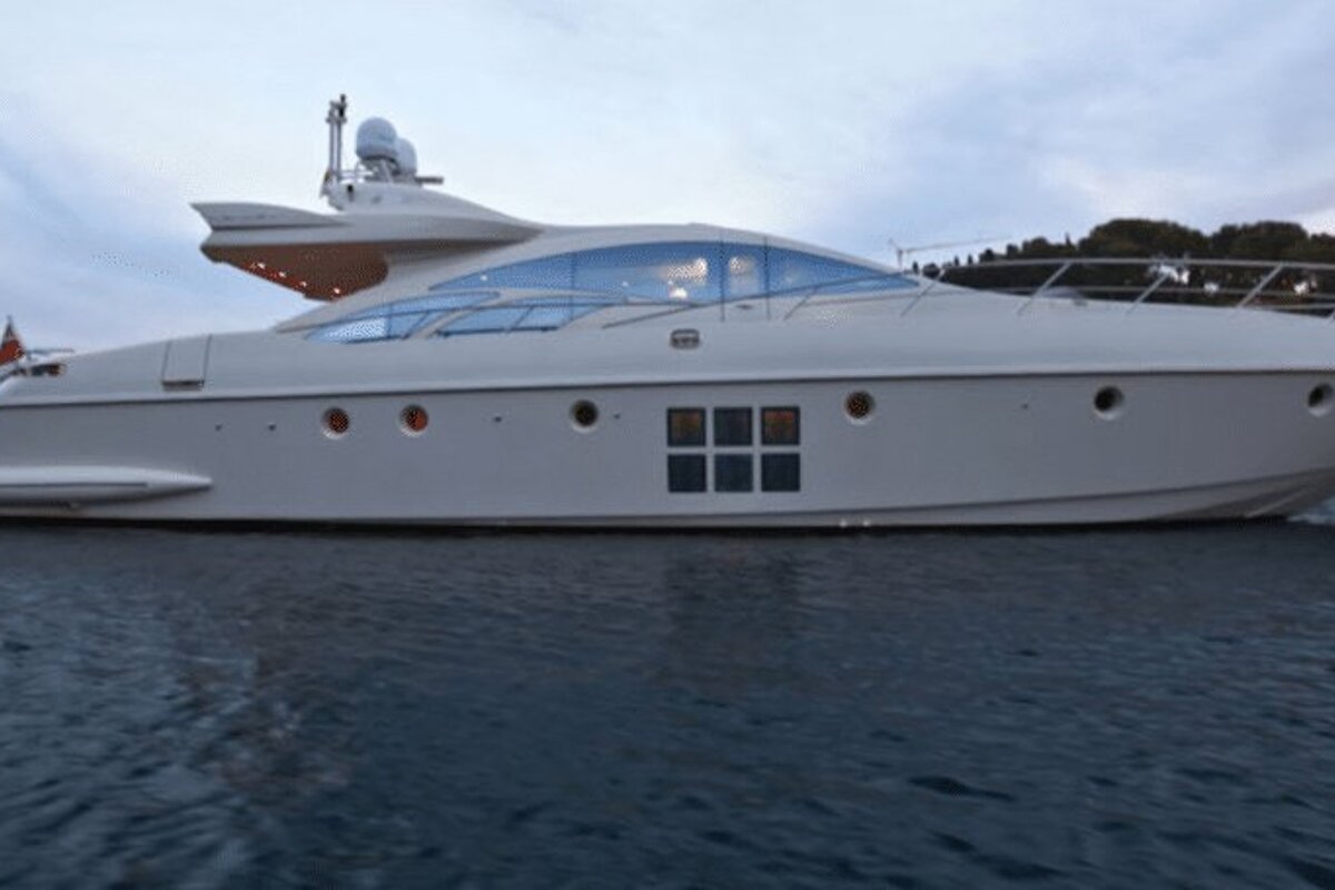 A large white yacht is floating on top of a body of water