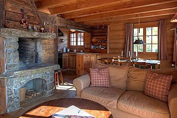 A living room with a stone fireplace and a couch
