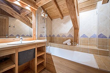 A bathroom with a bathtub a sink and a mirror