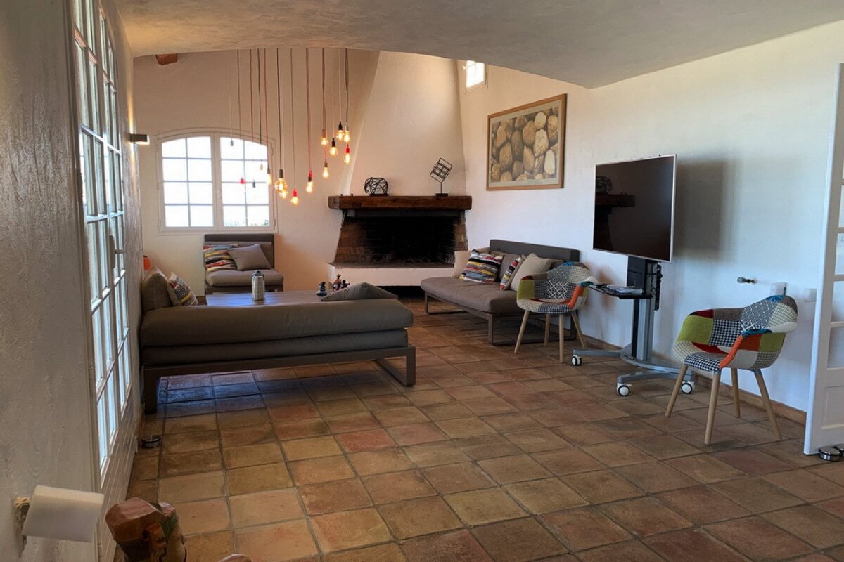 A living room with a fireplace and a flat screen tv