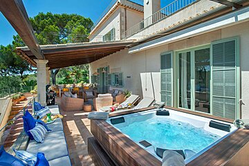 A large house with a hot tub in front of it