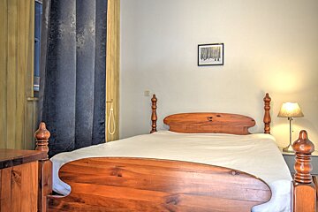 A bedroom with a bed and a picture on the wall