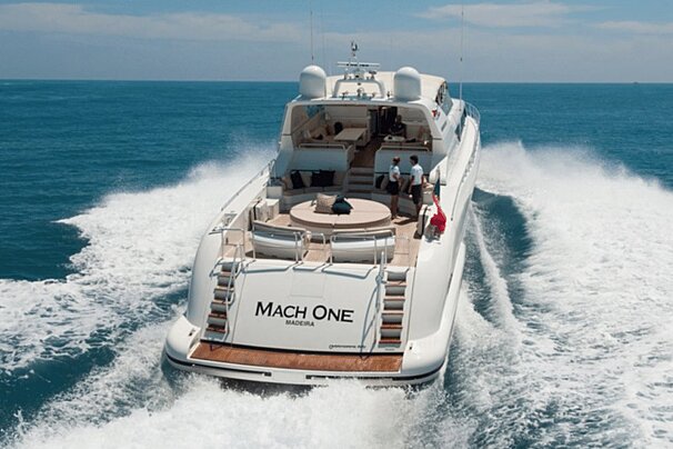 A white yacht with the name mach one on the back
