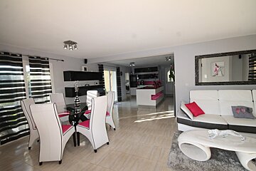A living room with a couch a table and chairs