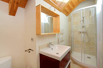 A bathroom with a sink and a walk in shower
