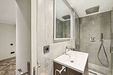 A bathroom with a sink a mirror and a shower