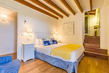 A bedroom with a painting on the wall that says know