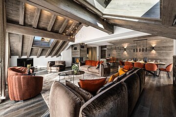 A living room with a couch and two chairs