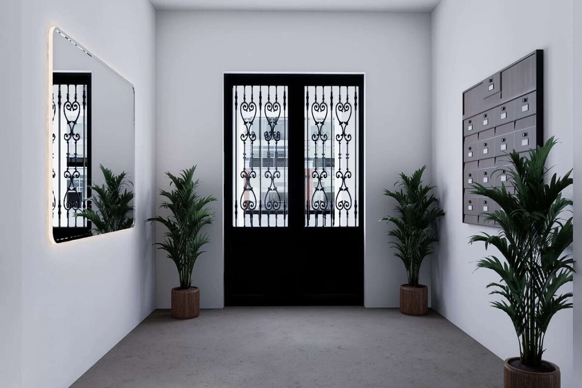 A modern entryway features ornate black double doors, a backlit mirror, multiple potted palm plants, and a wall-mounted mailbox system against white walls.