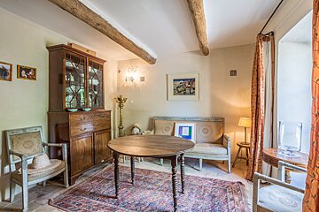 A room with a table and chairs and a picture on the wall