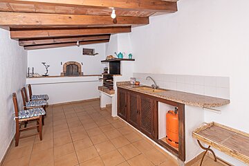 A kitchen with a propane tank under the counter