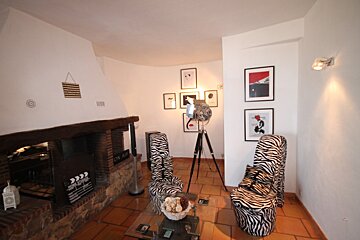 A living room with zebra print chairs and a fireplace