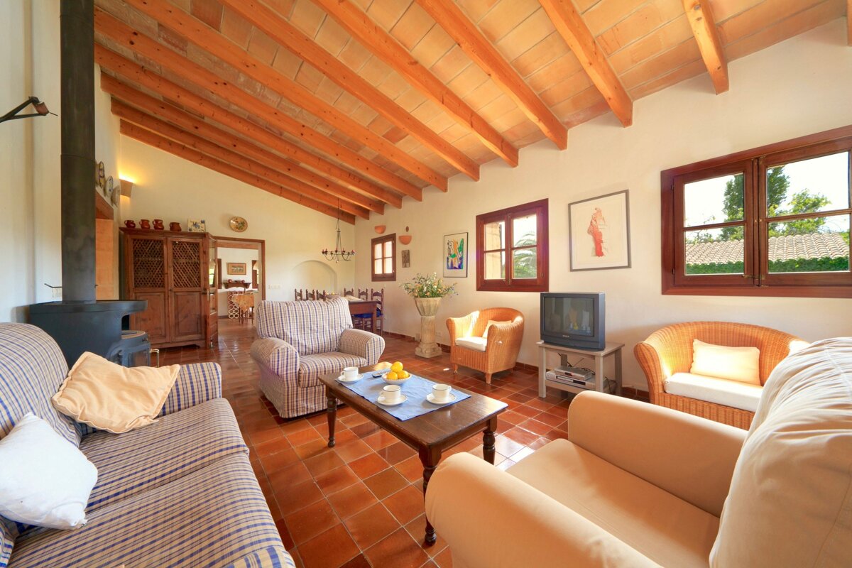 A living room with a couch and chairs and a television