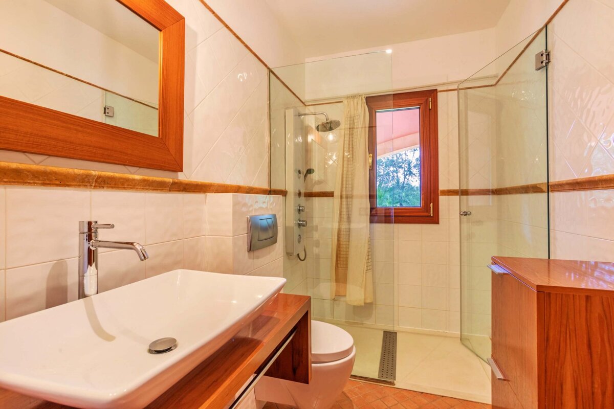 A bathroom with a sink and a walk in shower