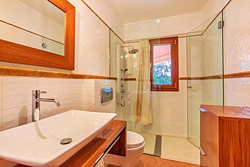 A bathroom with a sink and a walk in shower