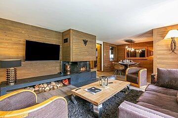 A living room with a fireplace and a flat screen tv