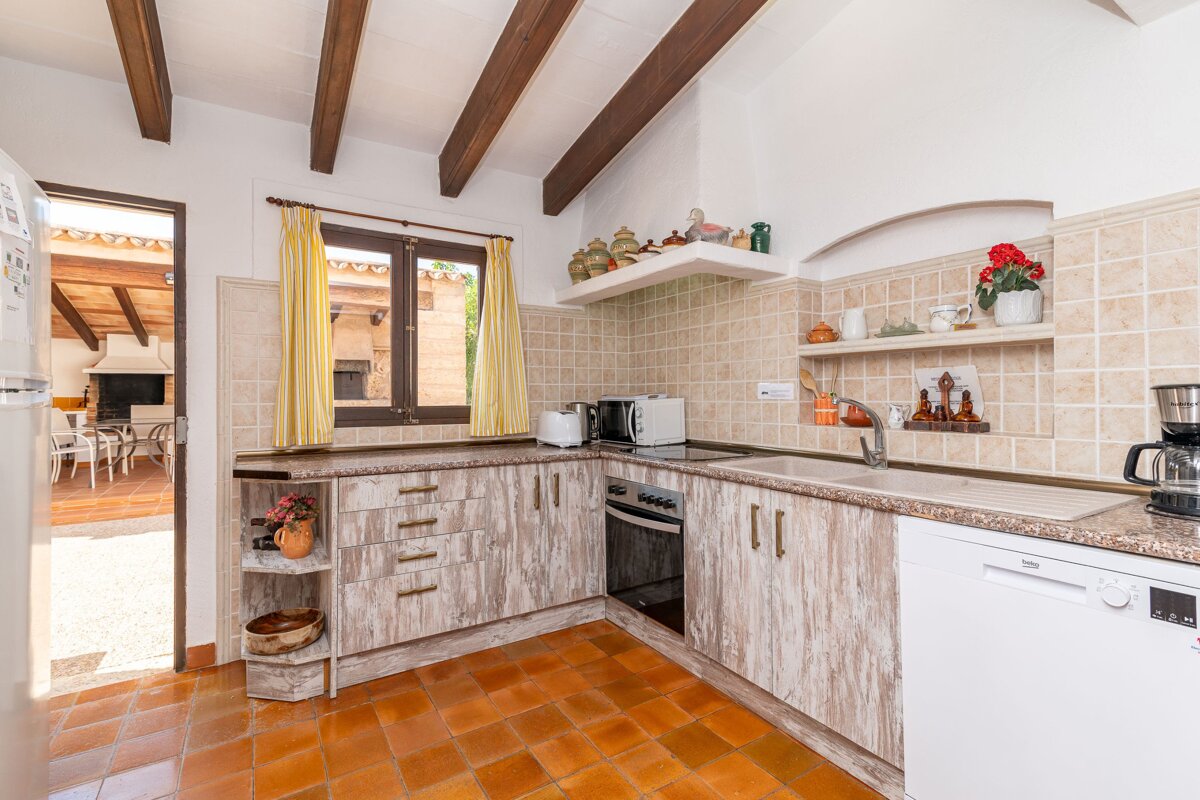 A kitchen with wooden cabinets and a white dishwasher