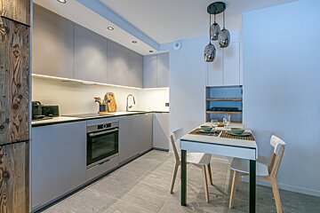 A floor plan of a house with a table and chairs