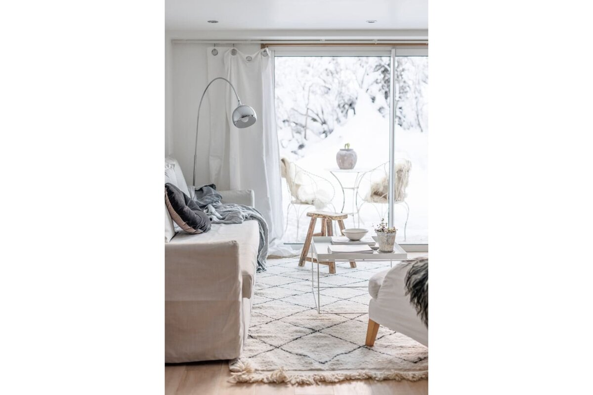 A living room with a couch and chairs and a sliding glass door