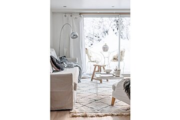 A living room with a couch and chairs and a sliding glass door